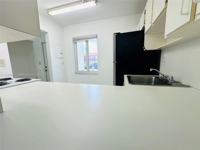 505 NW 177th St Unit 139, Miami Gardens, FL 33169 - kitchen with freestanding refrigerator, white cabinetry, and light countertops