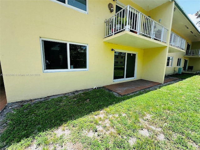 505 NW 177th St Unit 139, Miami Gardens, FL 33169 - back of house with stucco siding, a yard, and a balcony