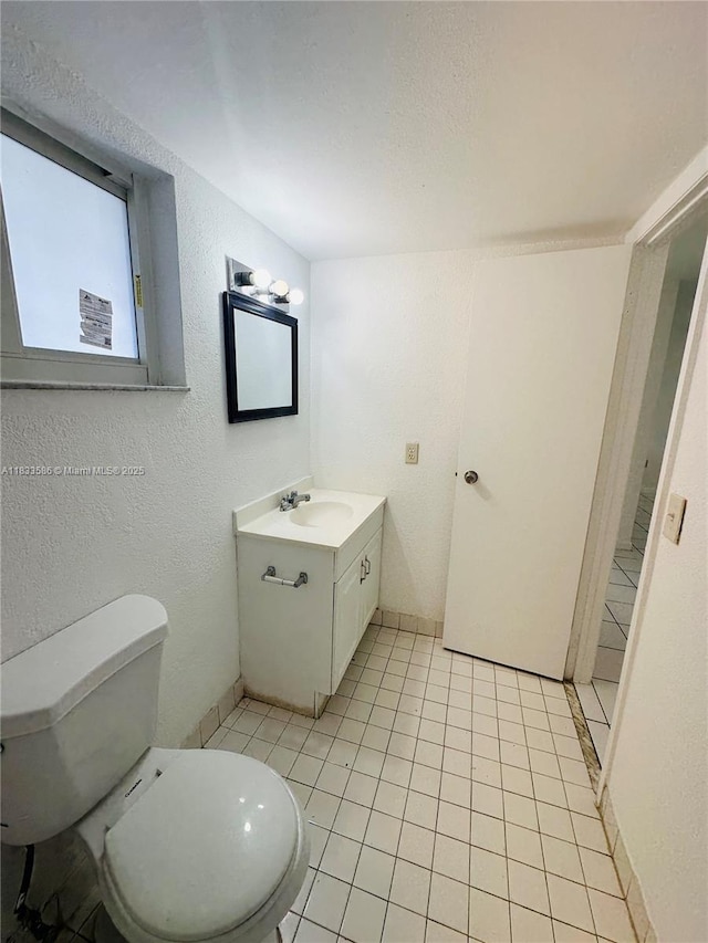 505 NW 177th St Unit 139, Miami Gardens, FL 33169 - half bathroom featuring vanity, tile patterned floors, and a textured wall