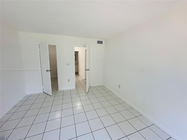 505 NW 177th St Unit 139, Miami Gardens, FL 33169 - spare room with a textured ceiling and light tile patterned floors