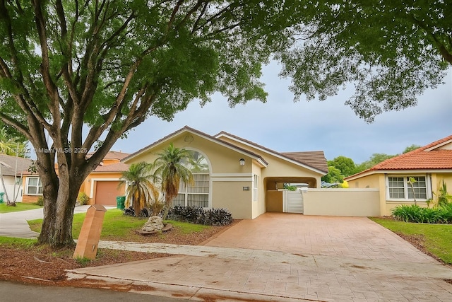 15126 NW 90th Ct, Miami Lakes, FL 33018 - view of front of property with decorative driveway, a gate, and stucco siding