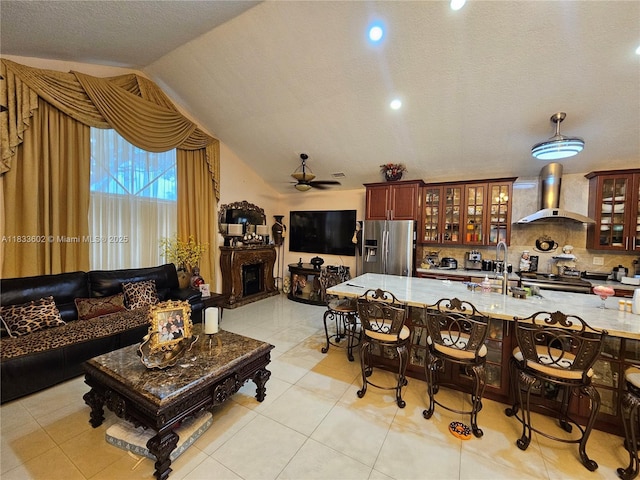 15126 NW 90th Ct, Miami Lakes, FL 33018 - kitchen with stainless steel fridge, wall chimney range hood, ceiling fan, decorative backsplash, and vaulted ceiling