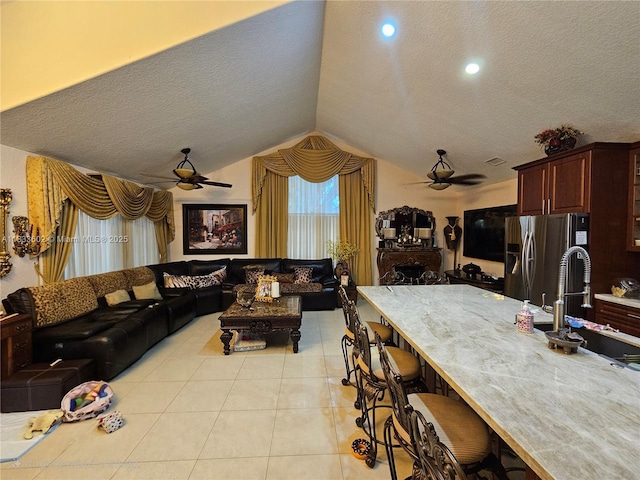 15126 NW 90th Ct, Miami Lakes, FL 33018 - living area with a ceiling fan, lofted ceiling, a textured ceiling, and light tile patterned flooring