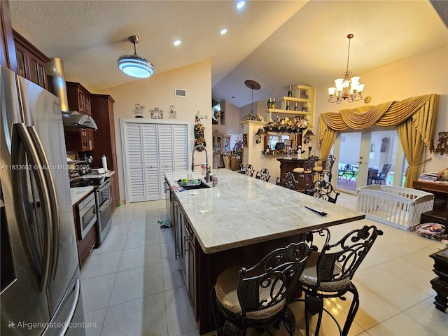 15126 NW 90th Ct, Miami Lakes, FL 33018 - kitchen featuring stainless steel appliances, tile patterned flooring, lofted ceiling, a chandelier, and hanging light fixtures