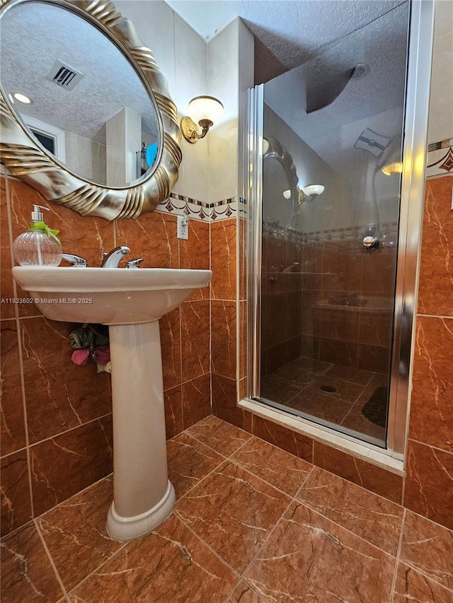 15126 NW 90th Ct, Miami Lakes, FL 33018 - full bath featuring a stall shower, tile walls, and a textured ceiling