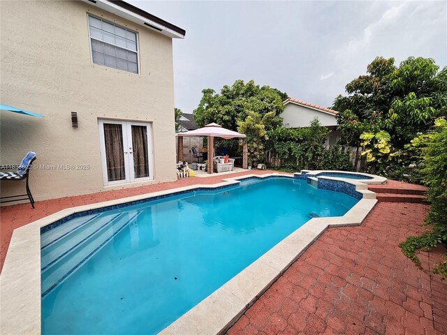 15126 NW 90th Ct, Miami Lakes, FL 33018 - view of swimming pool featuring a gazebo, a patio, french doors, and a pool with connected hot tub