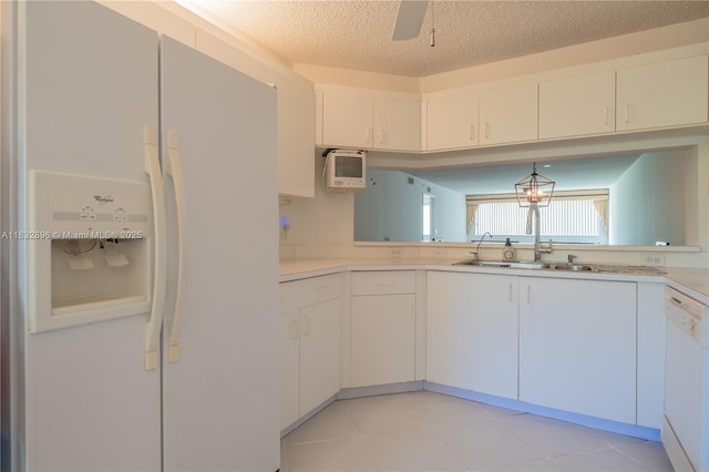 2541 N Nob Hill Rd Unit 309, Sunrise, FL 33322 - kitchen with white appliances, light countertops, white cabinetry, a textured ceiling, and light tile patterned floors