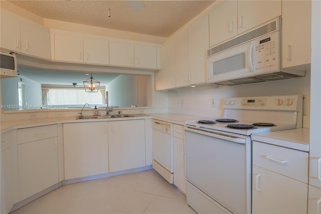 2541 N Nob Hill Rd Unit 309, Sunrise, FL 33322 - kitchen featuring white appliances, light countertops, light tile patterned floors, white cabinetry, and a textured ceiling