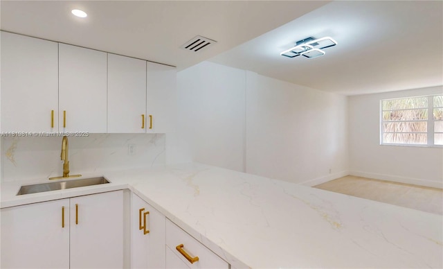1333 E Hallandale Beach Blvd Unit 326, Hallandale Beach, FL 33009 - kitchen featuring light stone counters, white cabinetry, recessed lighting, and tasteful backsplash