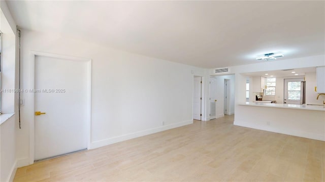 1333 E Hallandale Beach Blvd Unit 326, Hallandale Beach, FL 33009 - unfurnished living room with light wood-style flooring and a sink