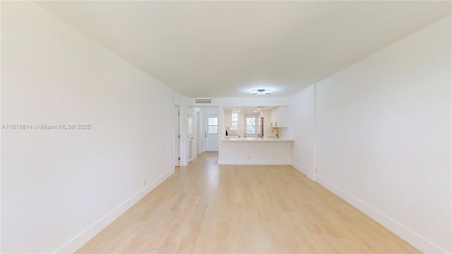 1333 E Hallandale Beach Blvd Unit 326, Hallandale Beach, FL 33009 - unfurnished living room with light wood-style floors and baseboards