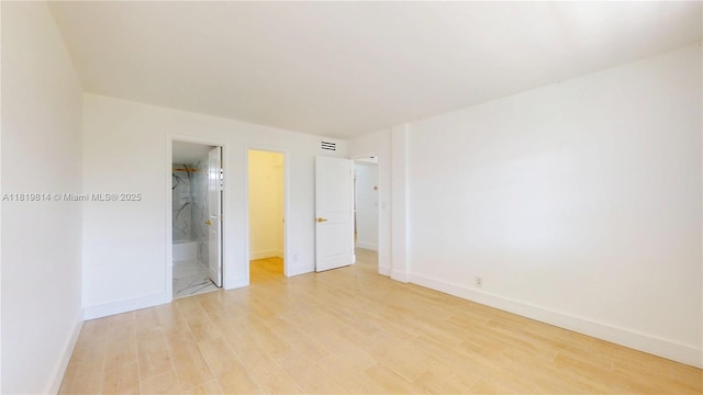 1333 E Hallandale Beach Blvd Unit 326, Hallandale Beach, FL 33009 - unfurnished bedroom featuring light wood-type flooring and ensuite bath