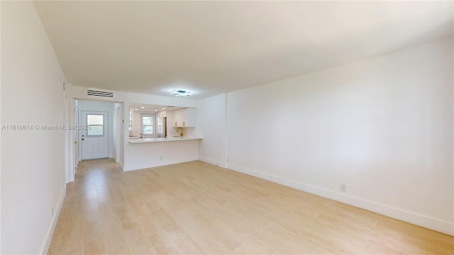 1333 E Hallandale Beach Blvd Unit 326, Hallandale Beach, FL 33009 - unfurnished living room featuring light wood-style flooring and baseboards