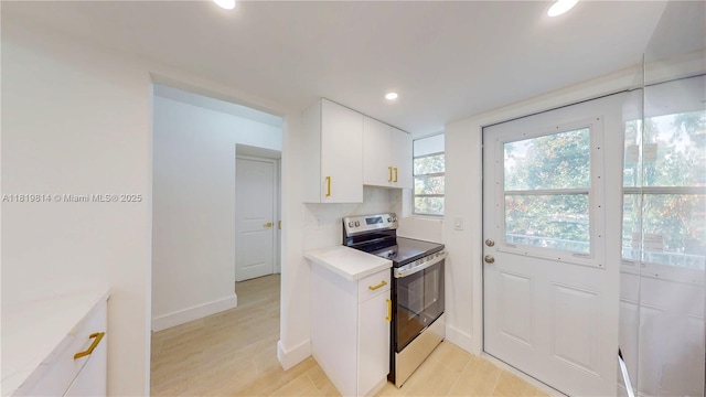 1333 E Hallandale Beach Blvd Unit 326, Hallandale Beach, FL 33009 - kitchen featuring stainless steel range with electric stovetop, recessed lighting, white cabinets, light countertops, and decorative backsplash
