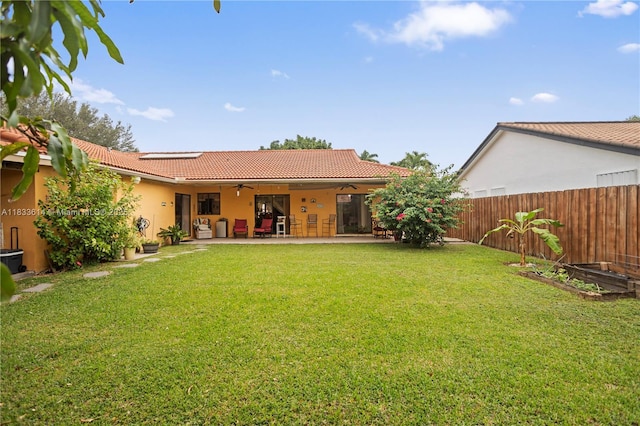15824 Cotswold Ct, Davie, FL 33331 - back of house featuring ceiling fan, a tile roof, a patio area, stucco siding, and a vegetable garden