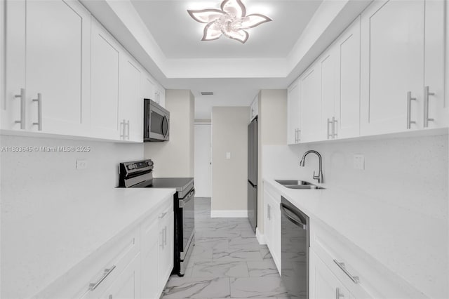 251 174th St Unit 1415, Sunny Isles Beach, FL 33160 - kitchen with stainless steel appliances, a raised ceiling, light countertops, and light marble finish flooring
