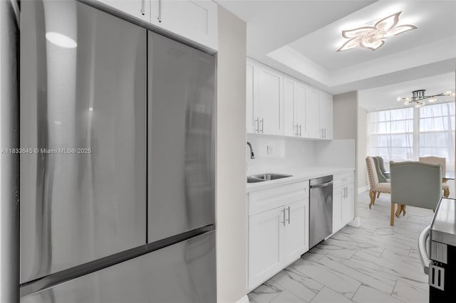 251 174th St Unit 1415, Sunny Isles Beach, FL 33160 - kitchen featuring appliances with stainless steel finishes, light marble finish flooring, light countertops, a chandelier, and white cabinets