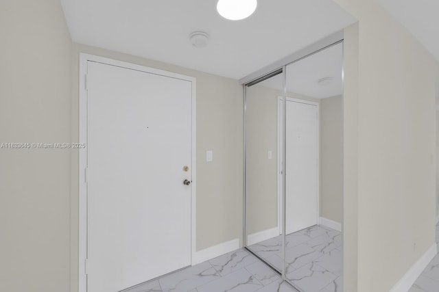 251 174th St Unit 1415, Sunny Isles Beach, FL 33160 - hallway with light marble finish flooring and baseboards