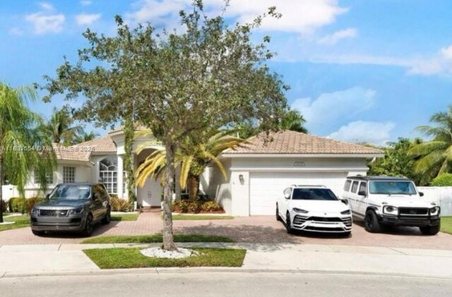 14095 NW 22nd Ct, Pembroke Pines, FL 33028 - view of front of house featuring decorative driveway and an attached garage