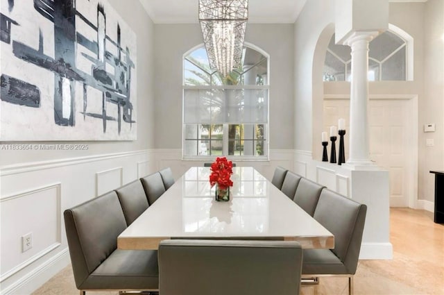 14095 NW 22nd Ct, Pembroke Pines, FL 33028 - dining room featuring decorative columns, arched walkways, a chandelier, a wainscoted wall, and a decorative wall