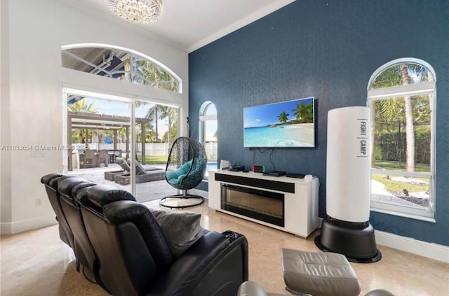 14095 NW 22nd Ct, Pembroke Pines, FL 33028 - living area with crown molding, a high ceiling, and a chandelier