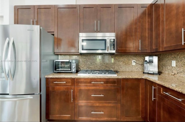 14095 NW 22nd Ct, Pembroke Pines, FL 33028 - kitchen featuring stainless steel appliances, tasteful backsplash, and light stone counters