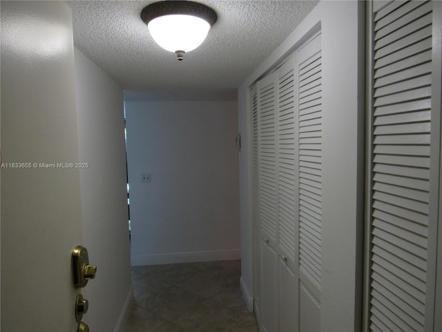 1101 River Reach Dr Unit 418, Fort Lauderdale, FL 33315 - corridor with a textured ceiling and tile patterned floors