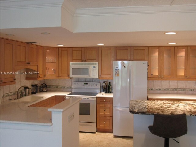 1101 River Reach Dr Unit 418, Fort Lauderdale, FL 33315 - kitchen featuring white appliances, ornamental molding, brown cabinets, decorative backsplash, and glass insert cabinets