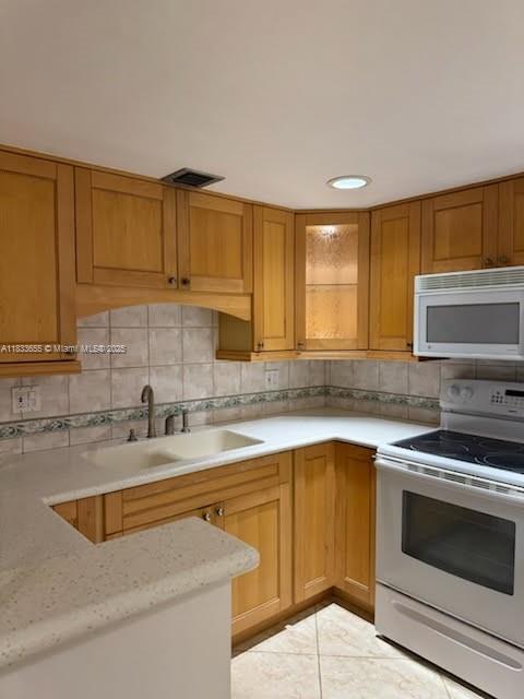 1101 River Reach Dr Unit 418, Fort Lauderdale, FL 33315 - kitchen with white appliances, decorative backsplash, and light tile patterned floors