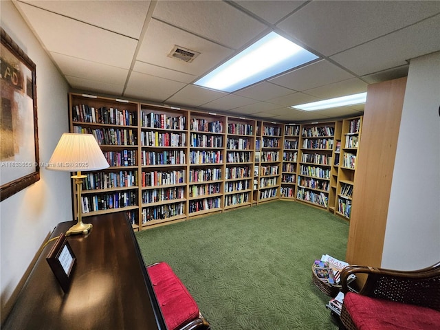 1101 River Reach Dr Unit 418, Fort Lauderdale, FL 33315 - living area featuring bookshelves, a drop ceiling, built in shelves, and carpet floors