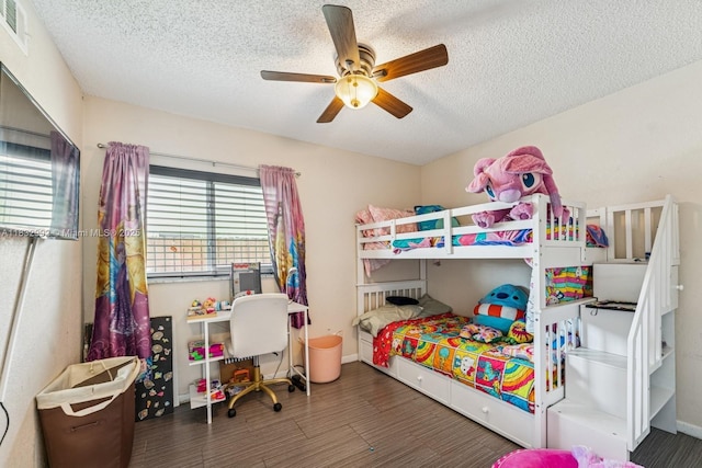 8107 NW 73rd Ter, Tamarac, FL 33321 - bedroom featuring wood finished floors, a textured ceiling, and ceiling fan