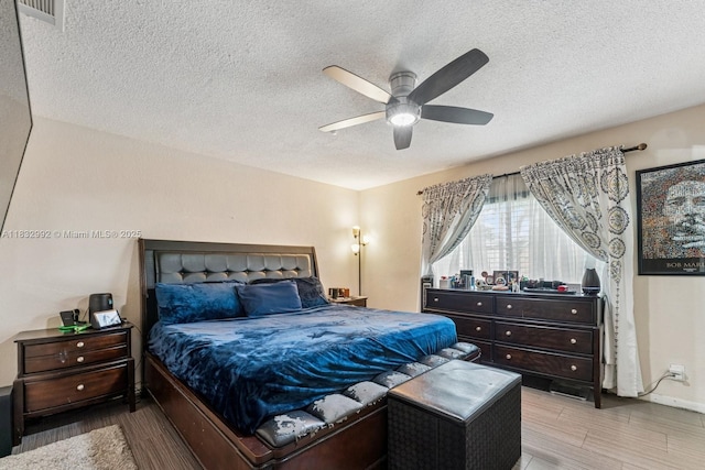 8107 NW 73rd Ter, Tamarac, FL 33321 - bedroom featuring a textured ceiling, wood finished floors, and a ceiling fan