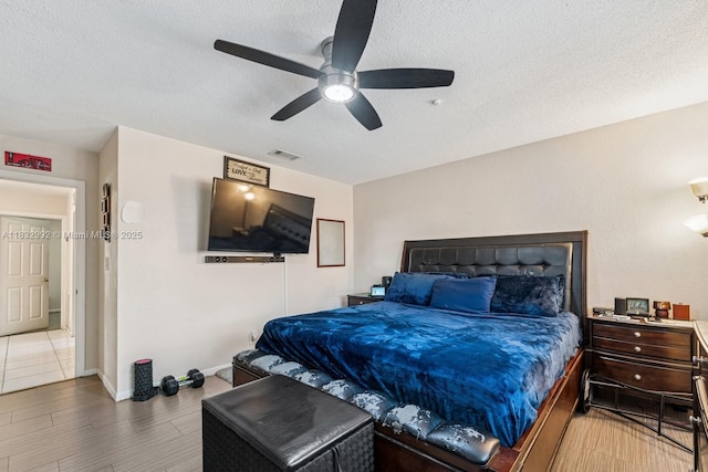8107 NW 73rd Ter, Tamarac, FL 33321 - bedroom featuring a textured ceiling, wood finished floors, and a ceiling fan