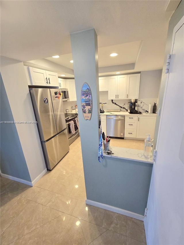 500 Bayview Dr Unit 732, Sunny Isles Beach, FL 33160 - kitchen with stainless steel appliances, white cabinets, light countertops, light tile patterned floors, and recessed lighting