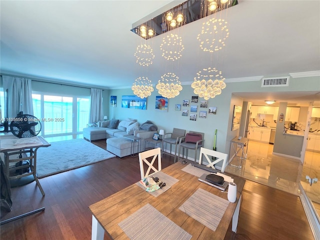 500 Bayview Dr Unit 732, Sunny Isles Beach, FL 33160 - dining area featuring wood finished floors, ornamental molding, and a chandelier