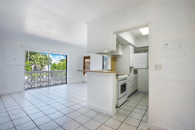 719 Euclid Ave Unit 7, Miami Beach, FL 33139 - kitchen with white electric stove, light tile patterned flooring, a peninsula, and white cabinets