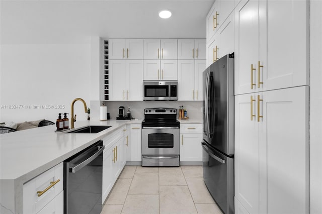 8242 NW 107th Ct Unit 7-12, Doral, FL 33178 - kitchen with stainless steel appliances, a peninsula, light countertops, white cabinetry, and recessed lighting