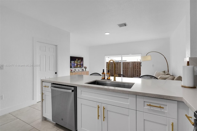 8242 NW 107th Ct Unit 7-12, Doral, FL 33178 - kitchen featuring stainless steel dishwasher, white cabinets, light countertops, light tile patterned flooring, and open floor plan