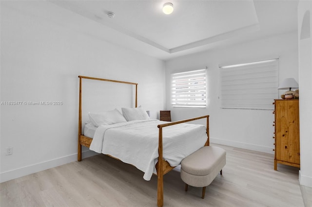 8242 NW 107th Ct Unit 7-12, Doral, FL 33178 - bedroom featuring light wood finished floors and a tray ceiling