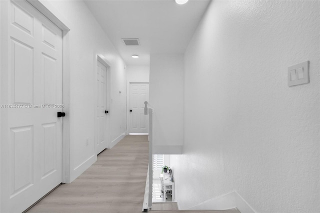 8242 NW 107th Ct Unit 7-12, Doral, FL 33178 - hall with light wood-type flooring and a textured wall