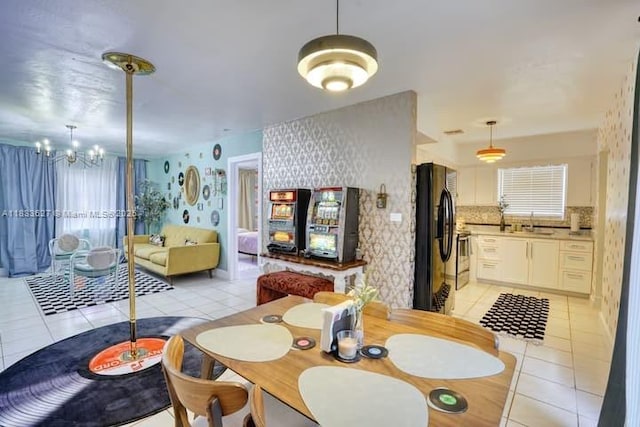6443 Perry St, Hollywood, FL 33024 - dining space with light tile patterned flooring, a chandelier, and wallpapered walls
