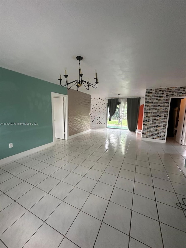 6443 Perry St, Hollywood, FL 33024 - spare room with a chandelier, light tile patterned floors, and an accent wall