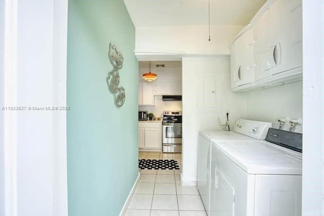 6443 Perry St, Hollywood, FL 33024 - washroom featuring cabinet space, washing machine and clothes dryer, and light tile patterned floors