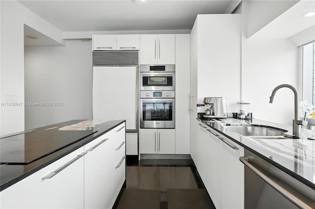 1435 Brickell Ave Unit 3512, Miami, FL 33131 - kitchen with stainless steel double oven, dishwasher, built in fridge, and white cabinets