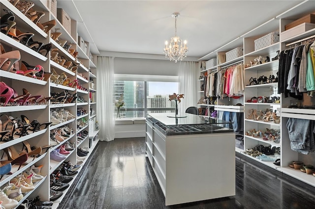 1435 Brickell Ave Unit 3512, Miami, FL 33131 - spacious closet featuring a chandelier and dark wood-style flooring