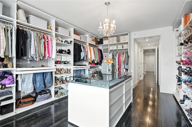 1435 Brickell Ave Unit 3512, Miami, FL 33131 - spacious closet featuring dark wood-style floors and a chandelier