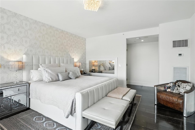 1435 Brickell Ave Unit 3512, Miami, FL 33131 - bedroom with wallpapered walls, an accent wall, and hardwood / wood-style floors