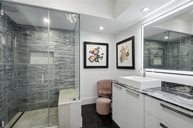 1435 Brickell Ave Unit 3512, Miami, FL 33131 - full bath featuring vanity, a stall shower, wood finished floors, and recessed lighting