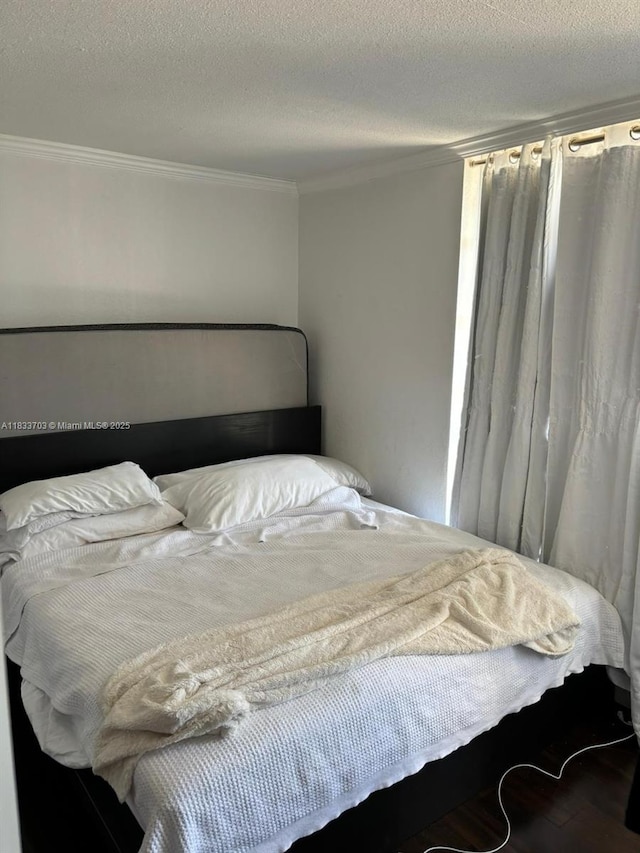 1750 NE 115th St Unit 608, Miami, FL 33181 - bedroom featuring crown molding, wood finished floors, and a textured ceiling