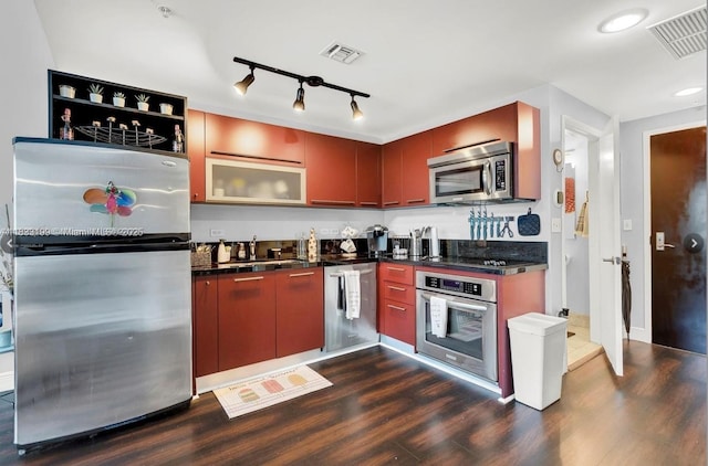 244 Biscayne Blvd Unit 440, Miami, FL 33132 - kitchen featuring stainless steel appliances, dark countertops, and dark wood-style flooring